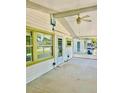 Screened-in patio featuring durable concrete flooring, a ceiling fan, and white vinyl siding at 4485 49Th N Ave, St Petersburg, FL 33714