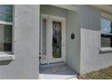 Welcoming front entrance with a glass door, 'welcome' mat, and sidelight window at 5104 2Nd E Ave, Palmetto, FL 34221