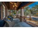 Inviting front porch with ceiling fan and comfortable seating area at 525 Lexington St, Dunedin, FL 34698