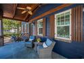 Charming front porch with seating, ceiling fan, and beautiful wood accents and shutters at 525 Lexington St, Dunedin, FL 34698