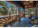 Spacious front porch with wicker furniture to sit and enjoy the Florida sunshine at 525 Lexington St, Dunedin, FL 34698