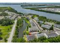Stunning aerial view of a waterfront townhome community with lush greenery and scenic water views of the bay at 618 Wheaton Trent Pl, Tampa, FL 33619