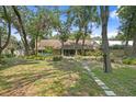 Lush backyard with mature trees and manicured landscaping; a tranquil retreat at 6213 S Queensway Dr, Temple Terrace, FL 33617