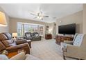 Cozy living room with large bay window, plush carpeting, and comfortable seating, ideal for relaxation at 6352 Huntington Dr, Zephyrhills, FL 33542