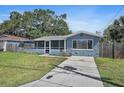 Inviting single Gathering home with a screened in front porch and a well-maintained driveway at 6481 64Th N Ave, Pinellas Park, FL 33781
