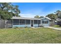 Charming single Gathering home with a screened in front porch and a well-maintained lawn at 6481 64Th N Ave, Pinellas Park, FL 33781