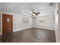 Bright living room with hardwood floors, ceiling fan, and plenty of natural light at 6481 64Th N Ave, Pinellas Park, FL 33781