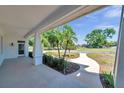 Spacious front porch overlooking a landscaped yard with a curved walkway, providing a welcoming entrance at 806 Linwood Ter, Lutz, FL 33549