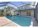 The backyard features a screened-in pool and patio area at 9107 Gablewood Pl, Land O Lakes, FL 34638