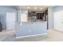 Open kitchen featuring stainless steel appliances, granite counters, and breakfast bar at 9205 English Oaks Ln, Riverview, FL 33578