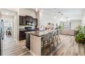 Open-concept kitchen with large island, stainless steel appliances, and seating for four at 11426 Sage Canyon Dr, Riverview, FL 33578