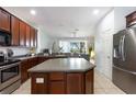 Spacious kitchen features stainless steel appliances, wooden cabinetry, and a center island with a stone countertop at 1105 Venetian Harbor Ne Dr, St Petersburg, FL 33702