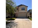 Two-story home with a two-car garage, neutral exterior paint, and landscaping, offering a welcoming curb appeal at 12717 Lemon Pepper Dr, Riverview, FL 33578