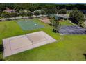Community park featuring a basketball court, sand volleyball court, playground, and covered picnic area at 1610 Raena Dr # 204, Odessa, FL 33556