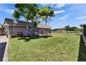 Well-kept home with lush lawn, mature trees and lake views offer a picturesque and serene setting at 201 Kings Blvd # 19, Sun City Center, FL 33573