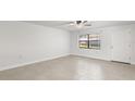 Bright living room featuring neutral walls, tile flooring, and a ceiling fan at 2131 Ridge S Rd # 130, Largo, FL 33778