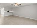 Bright living room with tile flooring and a ceiling fan creating a comfortable and stylish space at 2131 Ridge S Rd # 130, Largo, FL 33778