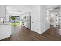 Modern kitchen with stainless steel appliances, white cabinets, and sliding doors to the backyard at 29629 Fedora Cir, Brooksville, FL 34602