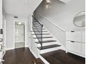 Bright foyer with hardwood floors, staircase with wrought iron railing, and white wainscoting at 3025 W Grovewood Ct # B, Tampa, FL 33629