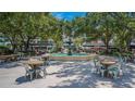 Beautiful outdoor plaza with a central fountain, surrounded by shaded seating and trees at 307 S Newport Ave, Tampa, FL 33606