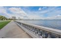 Scenic waterfront view with a concrete walkway and city skyline in the background under a bright blue sky with puffy clouds at 307 S Newport Ave, Tampa, FL 33606