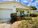 Charming single-story home featuring a well-manicured lawn and a welcoming front porch with seating at 3471 40Th N Way, St Petersburg, FL 33713