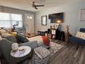 Bright living room featuring a comfortable sofa, a modern ceiling fan and contemporary decor at 3471 40Th N Way, St Petersburg, FL 33713