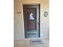 Close-up of front door with a seasonal decoration and welcome mat, showcasing condo's entry at 3516 Lake Bayshore Dr # K109, Bradenton, FL 34205