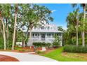 Inviting home with a classic design, surrounded by mature trees, showcasing curb appeal and charm at 380 Wellington Ave, Oldsmar, FL 34677