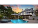 Backyard pool and jacuzzi with an elevated deck, outdoor space, and lush greenery for privacy at 380 Wellington Ave, Oldsmar, FL 34677