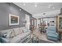 Spacious living room featuring modern decor and seamlessly connected to the kitchen and dining area at 400 4Th S Ave # 401, St Petersburg, FL 33701