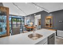 Open living room showcasing a sleek countertop, bar seating, and glass enclosed balcony at 400 4Th S Ave # 401, St Petersburg, FL 33701