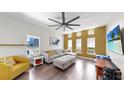 Spacious living room features modern furniture, hardwood floors, and a stylish accent wall at 4002 Carrollwood Palm Ct, Tampa, FL 33624