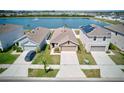 This residential property features a serene pond view and a well-maintained lawn at 588 Olive Conch St, Ruskin, FL 33570