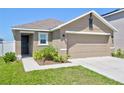 This single-Gathering home offers a well-maintained lawn, a garage and a welcoming front door at 588 Olive Conch St, Ruskin, FL 33570