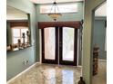 Inviting foyer with decorative double doors, tiled flooring and a chandelier at 5920 30Th S Ct, St Petersburg, FL 33712