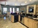 Spacious kitchen featuring stainless steel appliances, granite countertops, and an open layout to dining area at 5920 30Th S Ct, St Petersburg, FL 33712