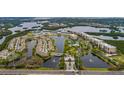 Beautiful aerial view of the Seminole Isle community featuring lakes, ponds, lush greenery, and well-maintained buildings at 7040 Key Haven Rd # 601, Seminole, FL 33777