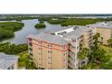 Aerial view of condos featuring multiple balconies and views of surrounding greenery at 7040 Key Haven Rd # 601, Seminole, FL 33777