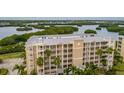 Exterior shot of the condo building displaying multiple floors and balconies for residents to relax and enjoy the views at 7040 Key Haven Rd # 601, Seminole, FL 33777