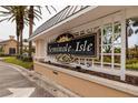 Entrance sign for Seminole Isle community, set against a backdrop of palm trees and landscaping at 7040 Key Haven Rd # 601, Seminole, FL 33777