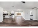 Expansive open-concept living room featuring modern vinyl floors, recessed lighting, and a bright open space at 7327 Jasmine Blvd, Port Richey, FL 34668