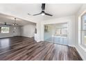 Bright open living room with new floors, modern ceiling fans, and sliding glass doors with a view at 7327 Jasmine Blvd, Port Richey, FL 34668