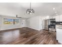 Bright living room featuring new floors, modern ceiling fans, stainless steel appliances and granite countertops at 7327 Jasmine Blvd, Port Richey, FL 34668