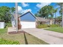 Well maintained home with a two car garage, manicured lawn, and mature landscaping enhancing its curb appeal at 7414 Mint Julep Dr, Riverview, FL 33578