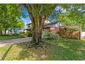 Beautiful exterior showing lawn, mature trees and attached carport at 7902 River Ridge Dr, Temple Terrace, FL 33637