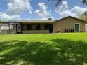 Spacious backyard with a well-maintained lawn, screened enclosure, and plenty of room for outdoor activities at 819 Satinleaf Ave, Oldsmar, FL 34677