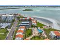Beautiful aerial view of beachfront condos with a pool and lush landscaping with beach access at 865 S Gulfview Blvd # 306, Clearwater Beach, FL 33767