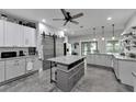 Spacious, modern kitchen with gray cabinets, granite countertops, stainless steel appliances, and a central island at 9019 S County Line Rd, Lithia, FL 33547