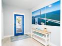 Bright foyer with a decorative door, console table, and bridge artwork at 1208 Bay Pine Blvd, Indian Rocks Beach, FL 33785